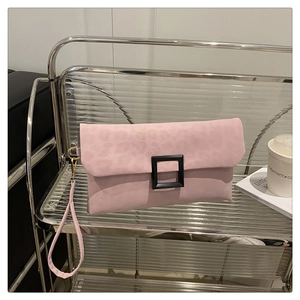 Detailed close-up of pink leopard print envelope clutch with a black buckle and wrist strap