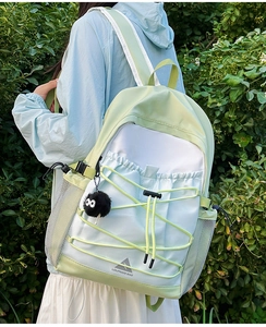 Detail of water-resistant nylon backpack with contrast stitching and elastic cord design
