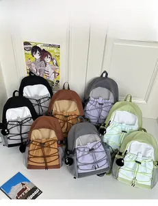 Outdoor canvas backpacks in various colors featuring bungee cords and plush ball charms