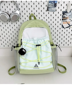 Detail of canvas backpack with contrast stitching and yellow elastic cord adjustment