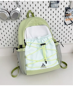 Close-up of contrast color canvas backpack with drawstring pocket and mesh side pockets