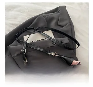Detail showing adjustable black leather strap and silver metal buckle of pink floral bag