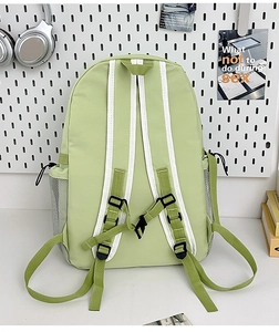 Detail of light green backpack with mesh side pockets and adjustable two-tone straps