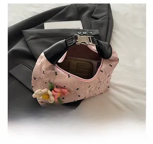 Pink pleated crossbody bag detail showing interior space for phone and wallet