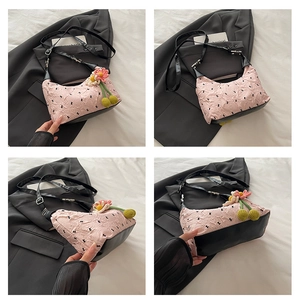 Collage of pink ruched handbag featuring black leather trim and crochet flower charm detail