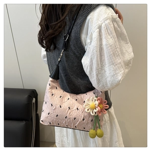 Light pink shoulder bag with pleated texture and knit floral cherry charm detail