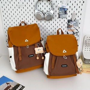 Detailed comparison of large and small color-block backpacks on a creative pegboard display