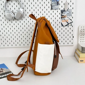 Detailed side view of caramel nylon backpack featuring white drawstring pockets and brown straps
