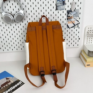 Rear view of mustard yellow hiking backpack with white side pockets on a study desk