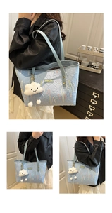 Detail of light blue quilted tote with wave embroidery and white cloud plush charm