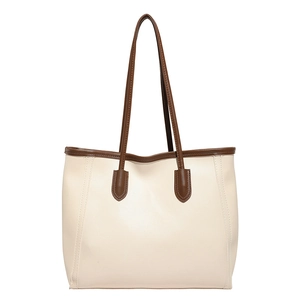 Chic beige and brown contrast tote bag in minimalist style for women on white background