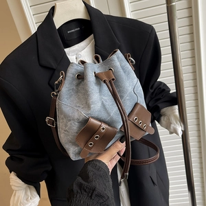 Retro denim bucket bag with leather drawstring and vintage wash blue finish for women
