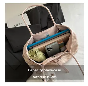 Detail view of pink woven tote bag interior showing large capacity for essentials