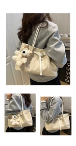 Detail of cream white woven tote bag featuring a cute plush bear charm and leather strap