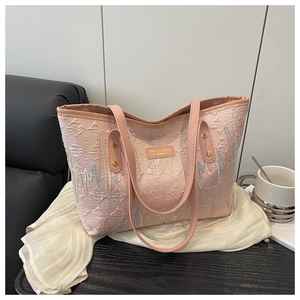 Close-up of pink jacquard tote bag with E-pattern fabric and rainbow embroidery details