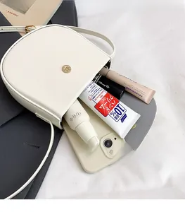 Interior view showing the storage space of this cream saddle bag for essentials