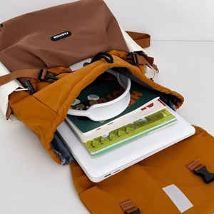 Macro view of multi-color hiking backpack interior showing large capacity for laptop and books