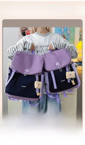 Detail of color-block hiking backpack featuring purple, blue, and black panels with charm