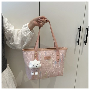 Pink tote bag with geometric embossed texture and cute smiling plush cloud pendant