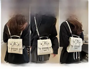 Three-way carry style display of cream lace and leather multi-functional backpack for women