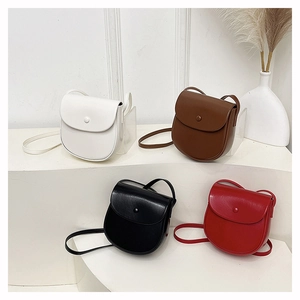 Minimalist mini saddle crossbody bags in white, brown, black, and red leather finish