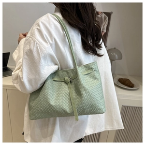 Detailed macro view of light green woven leather texture and elegant silver buckle