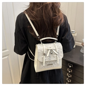 Lace floral backpack with heart butterfly charm shown in a lifestyle outdoor setting