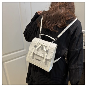 Detail view of mini lace backpack with butterfly bow and heart metal pendants on a model