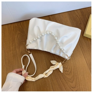 White ruched cloud bag featuring elegant pearl top handle and silk scarf strap detail