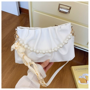 White pleated cloud bag detail with large pearl chain and silk ribbon decoration