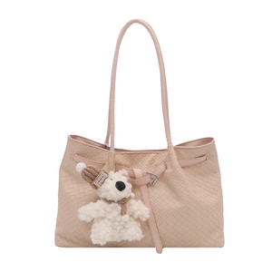 Chic beige woven leather tote bag for women with a cute plush bear charm accessory