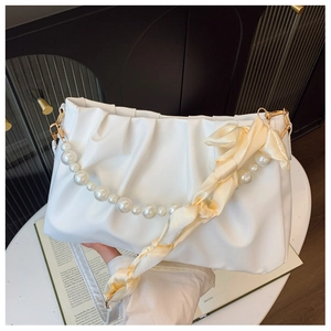 White ruched cloud bag featuring pearl chain strap and decorative silk scarf detail