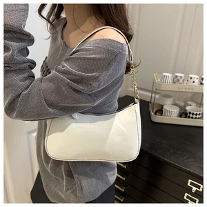 Close-up of white glossy underarm bag with gold chain and Fashion & Bags text logo