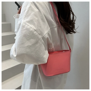 Détail du bas du sac seau rose avec le logo de marque FANYISSA gravé sur le cuir