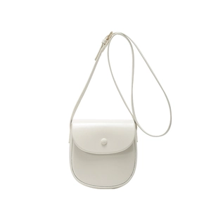 Minimalist beige crossbody saddle bag for women with round flap and adjustable strap