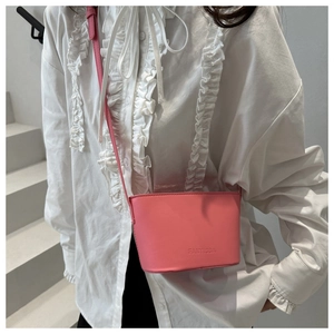 Pink synthetic leather bucket bag with FANYISSA logo and slender shoulder strap