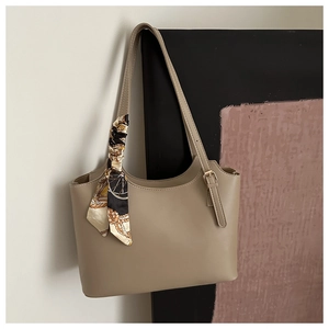 Detail of khaki PU leather tote bag with vintage patterned scarf and gold metal buckle