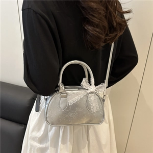 Minimalist silver Boston bag with embossed cartoon patterns and lace bow accessory