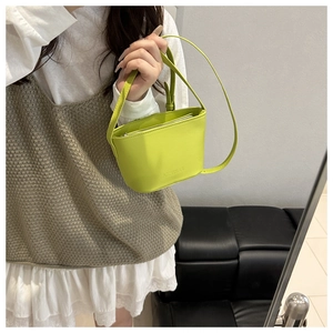 Detail of neon green crossbody bag with embossed logo and zipper closure