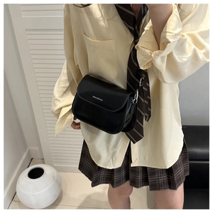 Detail of black matte leather square bag with FANTASTIC & BAG logo and silver hardware