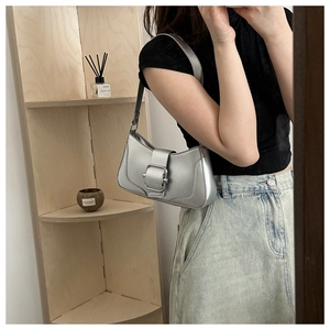 Silver metallic hobo bag with wide buckle detail shown in a stylish mirror selfie