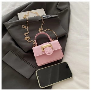 Close-up of pink mini flap bag featuring gold metal buckle and detachable chain strap