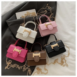 Flat lay of small flap handbags in five colors with golden H buckles and chain straps