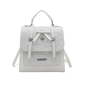 White mini backpack with floral embroidery, bow accent and heart charm for women