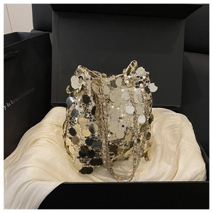 Détail du sac seau à paillettes dorées et argentées dans un coffret cadeau noir