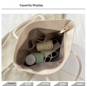 Spacious interior of beige crocodile pattern tote bag showing daily essentials