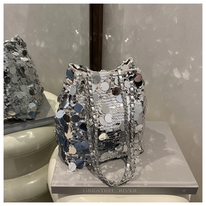 Gros plan des paillettes argentées et de la chaîne de ce sac seau chic
