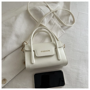 Mini flap crossbody bag in creamy white with 'FASHION' lettering and size comparison