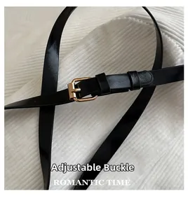 Detailed close-up of a black PU leather belt with a polished gold pin buckle and adjuster