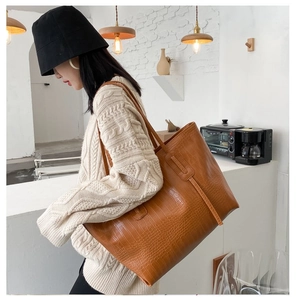 Close-up of brown crocodile pattern tote bag showing high-quality embossed texture